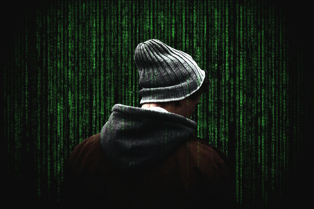 A hooded character with a computing related background